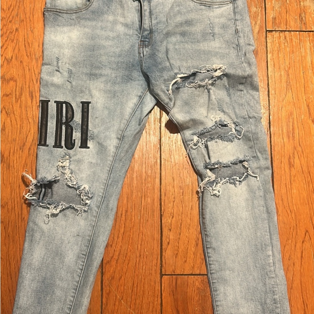 AMIRI Light Blue Distressed Skinny Jeans with Black Logo